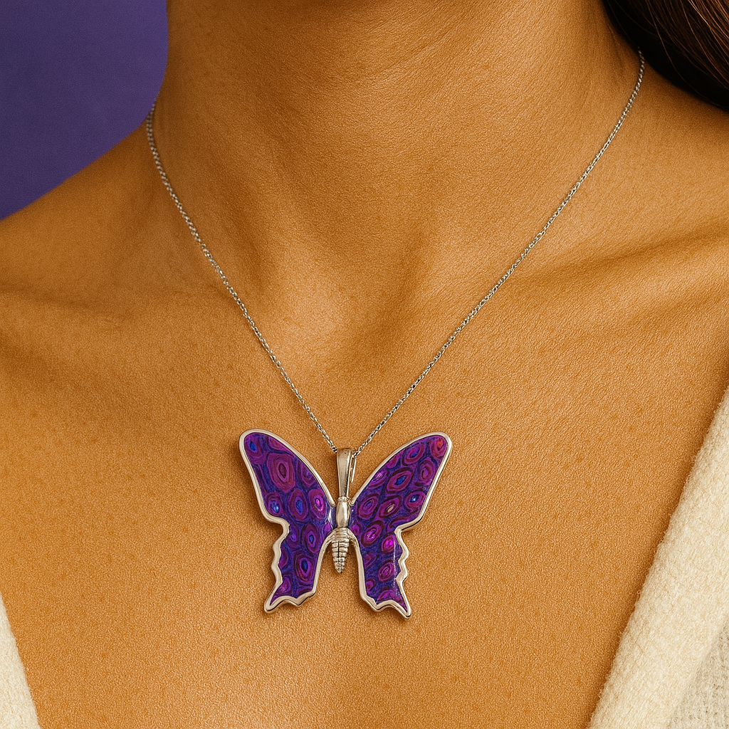 Butterfly pendant necklace on a person with a purple background