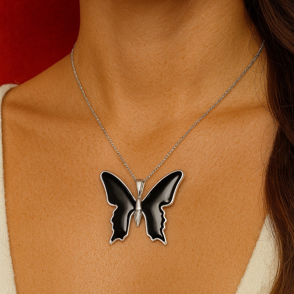 Butterfly pendant necklace on a person's neck with a red background