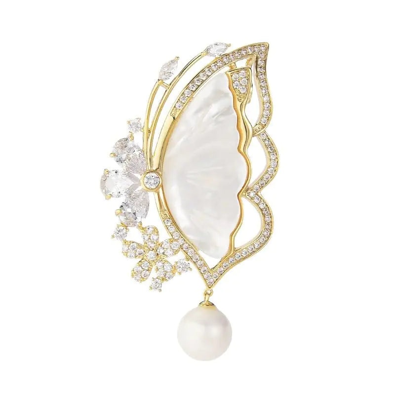 Elegant brooch with gold detailing, pearl, and crystals on a white background